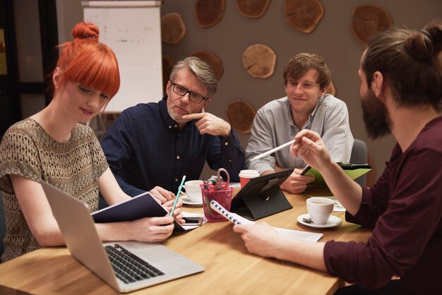 Gruppe kreativer Menschen, die das Ergebnis der Arbeit analysieren