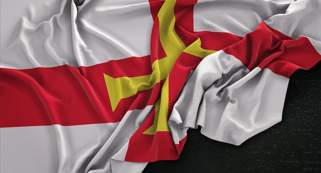 Guernsey-Flagge, die auf dunklem Hintergrund verstreut ist 3D Render