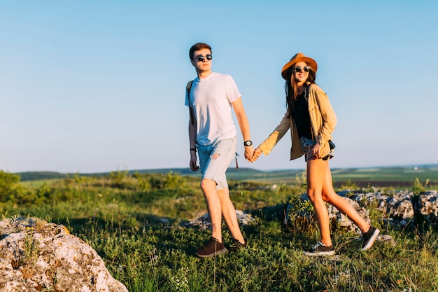 Händchenhalten des jungen Paares beim Wandern