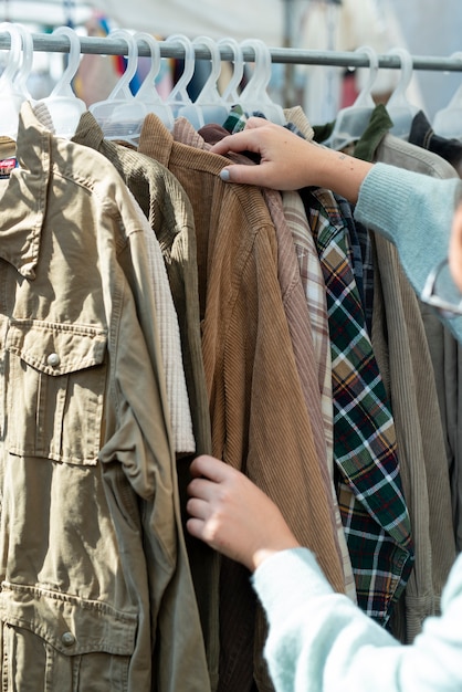 Hände halten Jacke auf Second-Hand-Markt