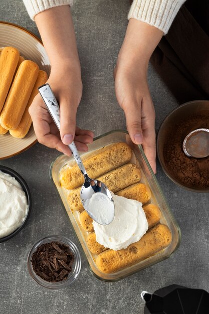 Hände von oben, die Tiramisu kochen