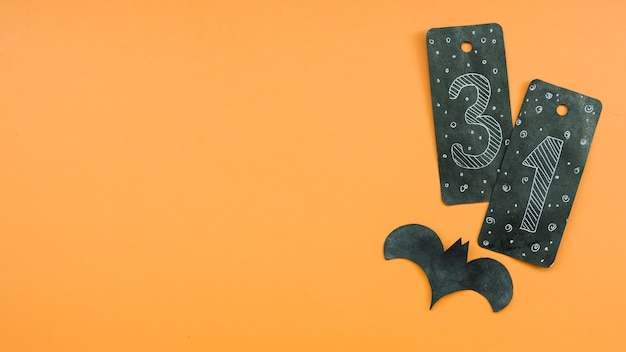 Kostenloses Foto halloween-komposition mit schwarzer karte mit nummer einunddreißig und schläger