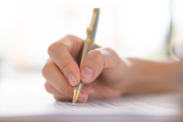 Hand mit Stift über Antragsformular