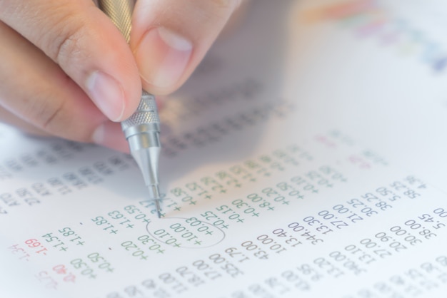 Hand schreiben auf Verschiedene Finanzdiagramme auf dem Tisch