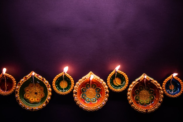 Happy diwali - schöne diwali diyas in der nacht mit blumen