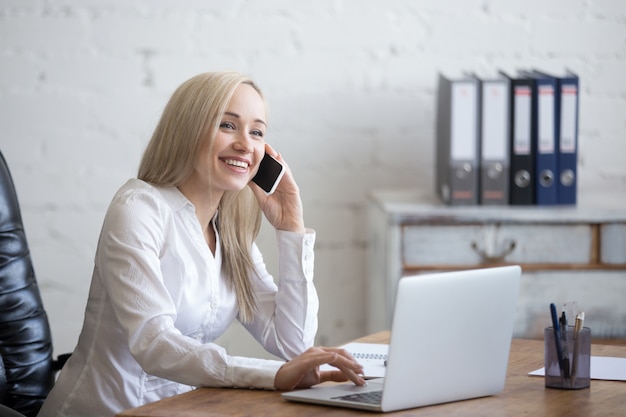 Kostenloses Foto happy geschäftsfrau arbeitet in ihrem büro