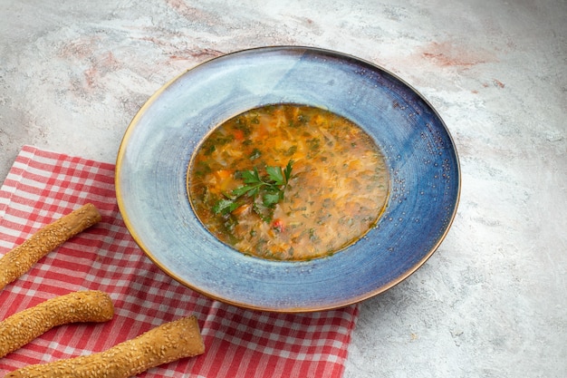 Heiße Gemüsesuppe der Vorderansicht mit Grün innerhalb Platte auf einem weißen Raum