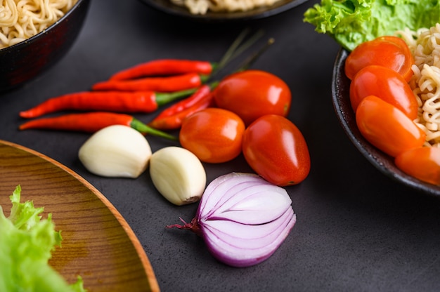 Helle Nahaufnahme der Scheiben, des Knoblauchs, der Tomate und der Pfeffer der roten Zwiebel. Tiefenschärfe