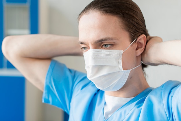 High Angle männliche Krankenschwester mit medizinischer Maske