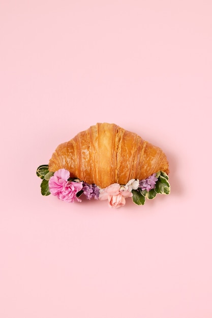 Kostenloses Foto hochwinkel-croissant und blumenarrangement