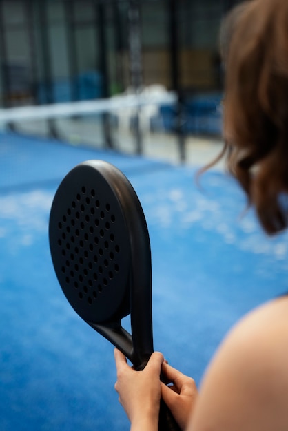 Hochwinkelige Frau, die Paddle-Tennis spielt