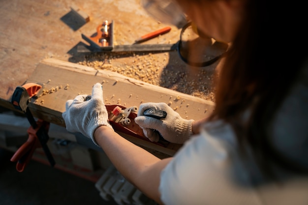 Hochwinkelige Frau mit Schutzhandschuhen