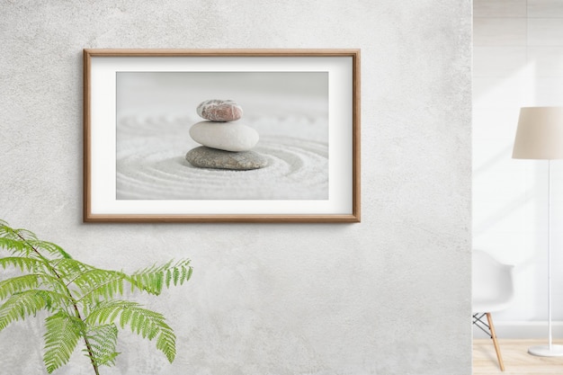 Kostenloses Foto hölzerner bilderrahmen mit zen-steinen-foto auf dem wandinnenkonzept