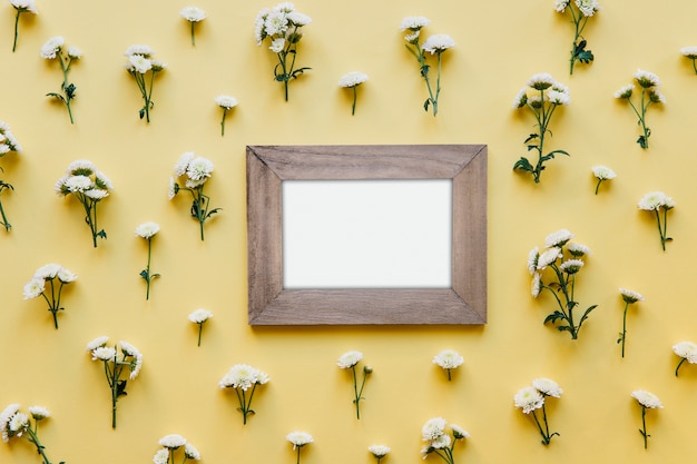 Kostenloses Foto hölzerner leerer rahmen in den blumen