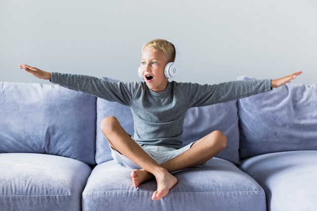 Hörende Musik des kleinen Jungen zu Hause