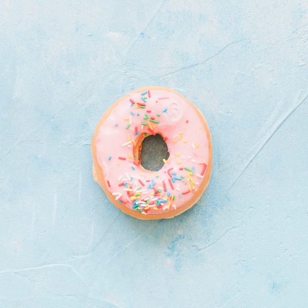 Kostenloses Foto hohe winkelsicht des frischen donuts auf blauem hintergrund