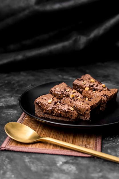 Hoher Winkel der Kuchenstücke auf Teller mit goldenem Löffel