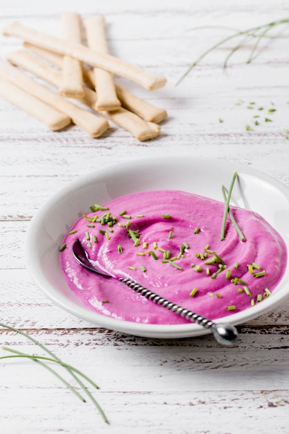 Hoher Winkel der rosa Soße auf Teller mit Grissini