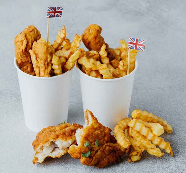 Hoher Winkel von Fish and Chips in Pappbechern mit britischen Flaggen