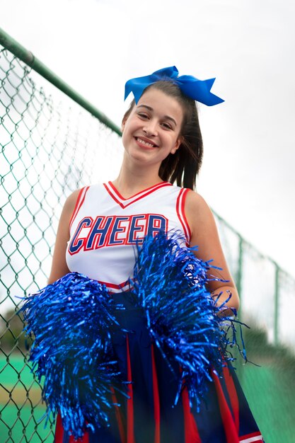 Hübsche weibliche Cheerleaderin in süßer Uniform