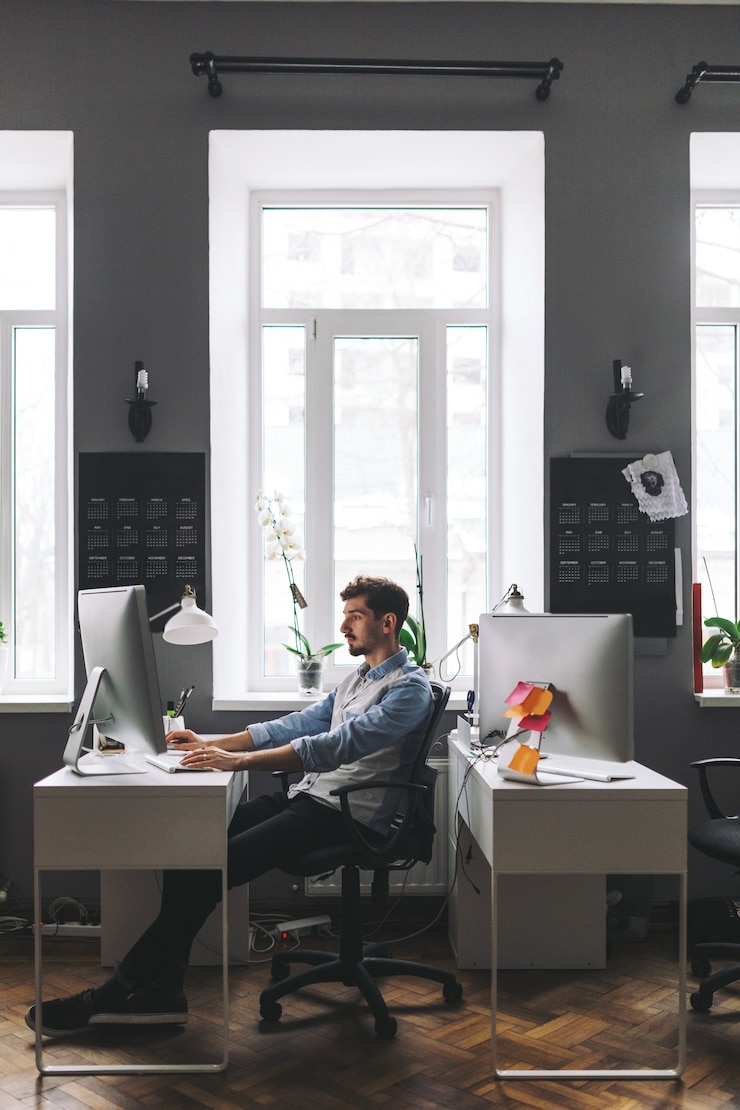 Kostenlose Foto hübscher geschäftsmann, der im büro arbeitet