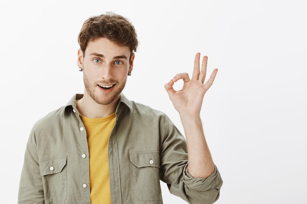 Hübscher glücklicher Mann, der im Studio aufwirft