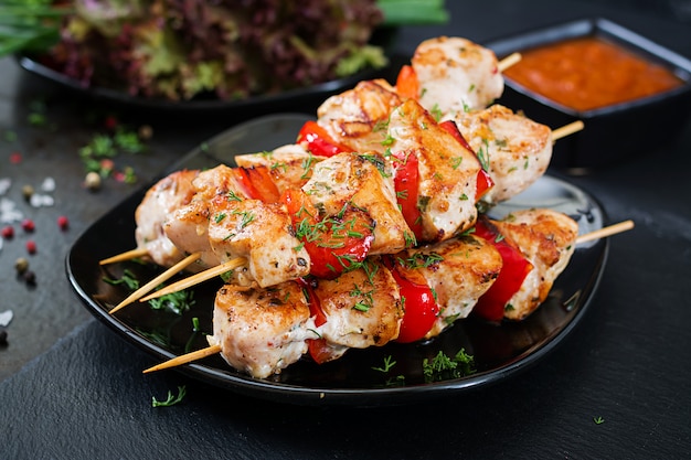 Hühnchen-Spieße mit Paprika-Scheiben und Dill.