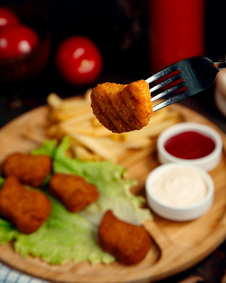 Kostenlose Foto hühnernuggets auf kopfsalat mit soßen