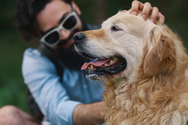 Hund und sein Besitzer - Cooler Hund und junger Mann, der Spaß hat