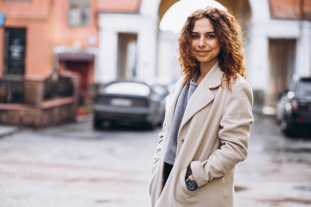 Ihre Frau mit dem lockigen Haar außerhalb der Straße