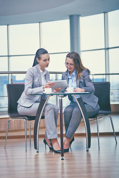 Intelligente Geschäftsfrauen mit einem Tablet arbeiten