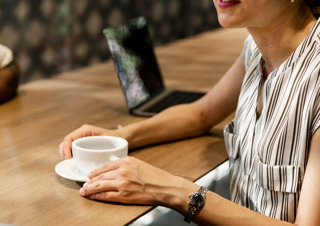 Japanische Frau, die einen Kaffee trinkt