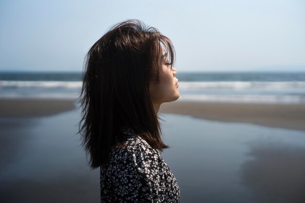 Japanische Frau mit mittlerer Aufnahme am Meer