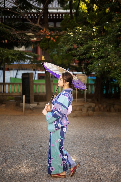 Kostenloses Foto japanische wagasa-regenschirmhilfe durch junge frau