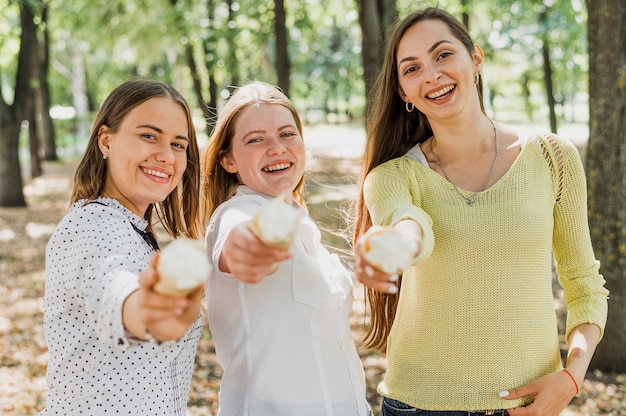 Jugendlicher, der der Kamera Eiscreme gibt