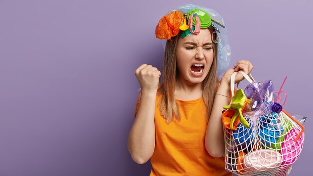 Kostenloses Foto junge blonde frau, die mit plastikmüll aufwirft