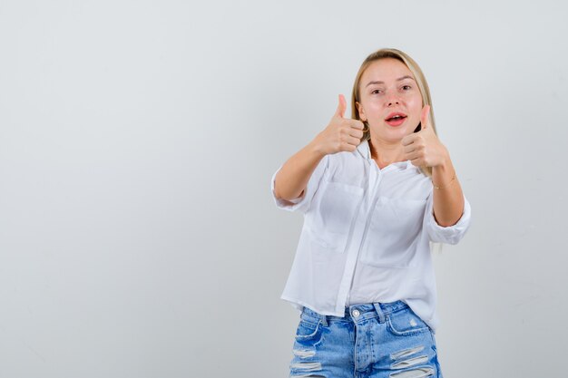 Junge blonde Frau in einem weißen Hemd