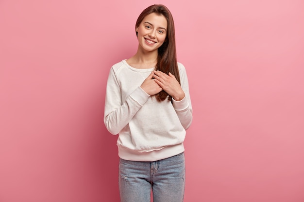 Junge brünette Frau in Jeans und Pullover