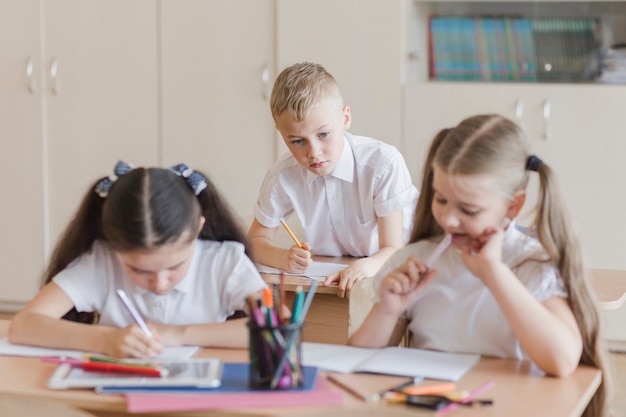 Junge, der Antworten von Klassenkameraden kopiert