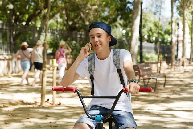 Junge, der ein BMX-Fahrrad im Park reitet