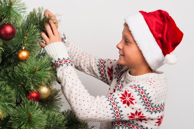 Junge, der Weihnachtsbaum verziert