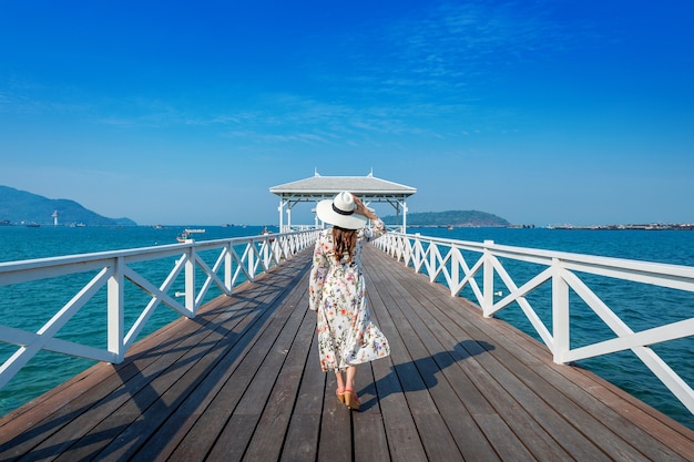 Junge Frau, die auf Holzbrücke in Si Chang Insel, Thailand geht.
