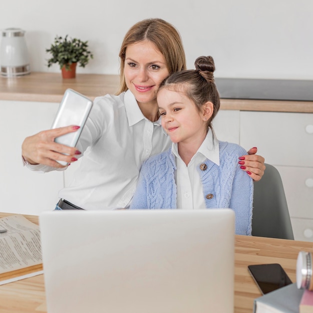 Junge Frau, die ein Selfie mit ihrer Tochter nimmt