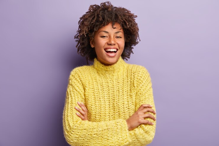 Kostenlose Foto junge frau mit afro-haarschnitt, der gelben pullover trägt
