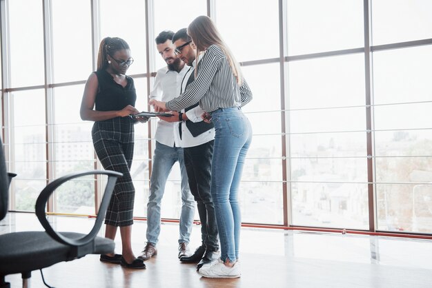 Junge Geschäftsleute diskutieren während eines Meetings im Büro gemeinsam über neue kreative Ideen