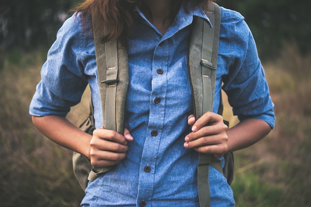 Kostenloses Foto junge hippie-mädchen mit rucksack im sommer feld zu fuß durch.