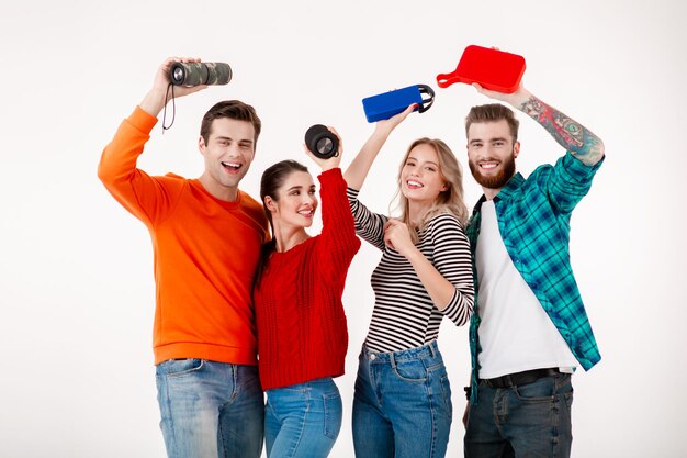 Junge Hipster-Gesellschaft von Freunden, die gemeinsam Spaß haben und lächeln, Musik auf drahtlosen Lautsprechern hören, tanzen, lachen, isolierter Studio-weißer Hintergrund in farbenfrohem, stilvollem Outfit