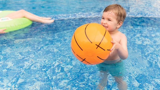 Junge im Pool mit Ball