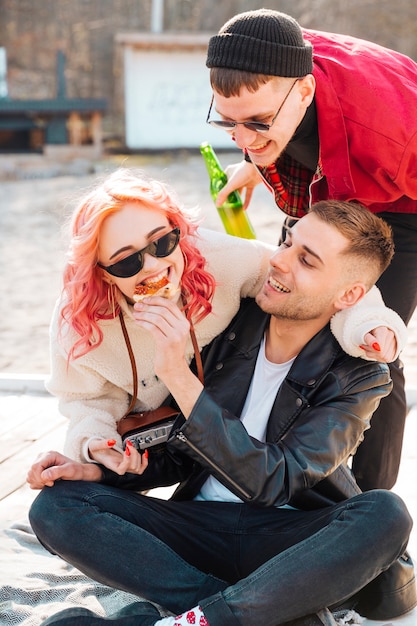 Junge lächelnde freunde, die draußen feiertag feiern