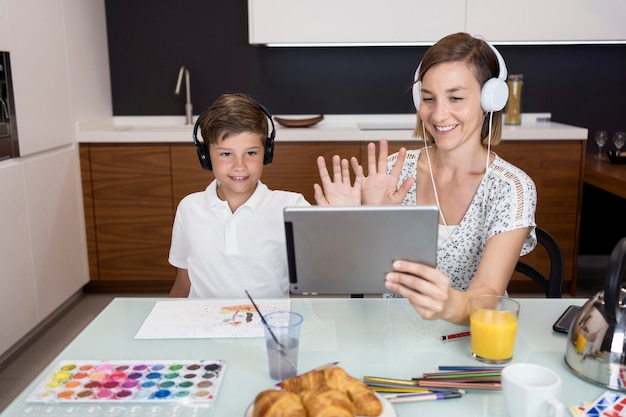 Junge macht Videokonferenz zusammen mit Mutter